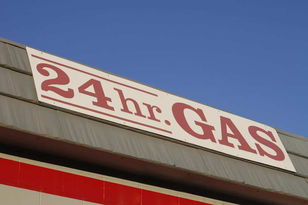 image of a 24-hour gas station sign, representing a potential trigger.