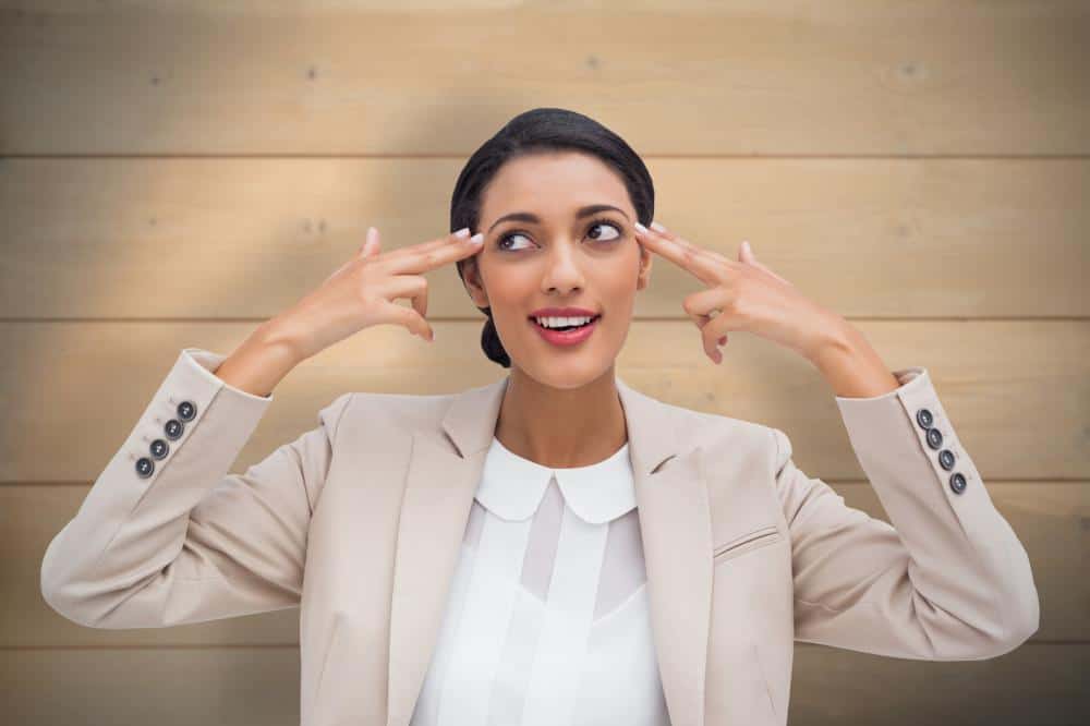 woman pointing at her own head thinking