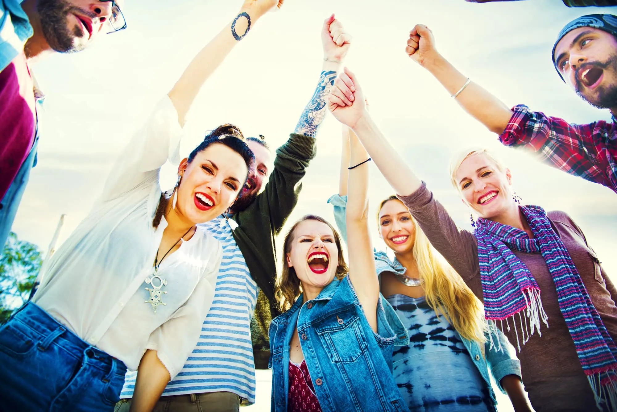 friends building resilience in rehab hands in the air